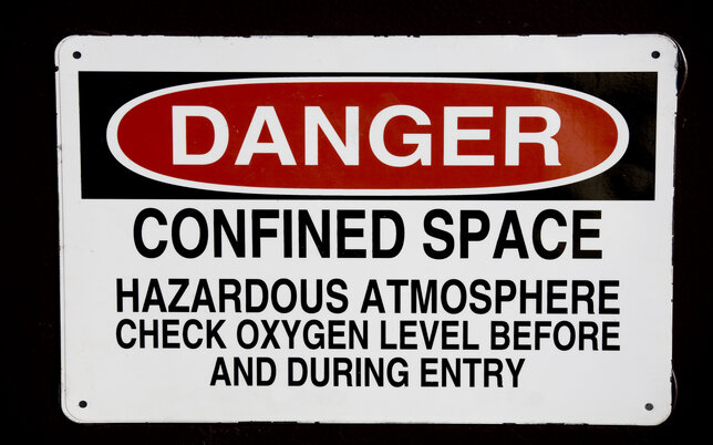 Danger confined space sign in red, black and white with black background
