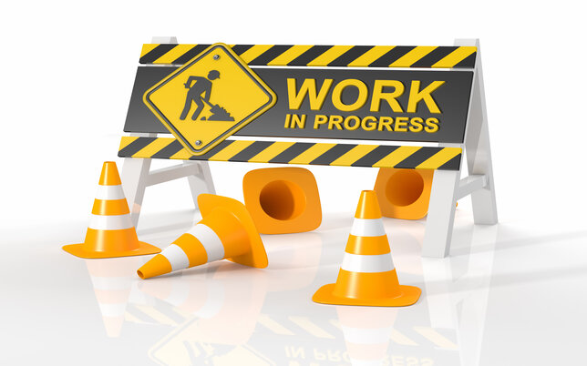 Work in progress sign in yellow with cones and white background