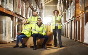 a warehouse team pose for a group shot